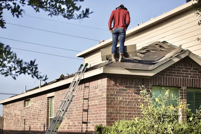 Professional roofer working on a residential roof in Arlington